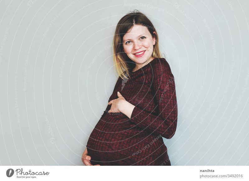 Really happy young pregnant woman happiness pregnancy family mom mother motherhood love lovely mood smile smiling cheerful pretty fashion dress tummy belly