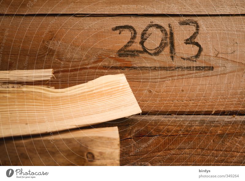 year of transformation Wall (barrier) Wall (building) Wooden wall Year date 2013 Esthetic Simple Original Warmth Brown Firewood Handwriting Colour photo