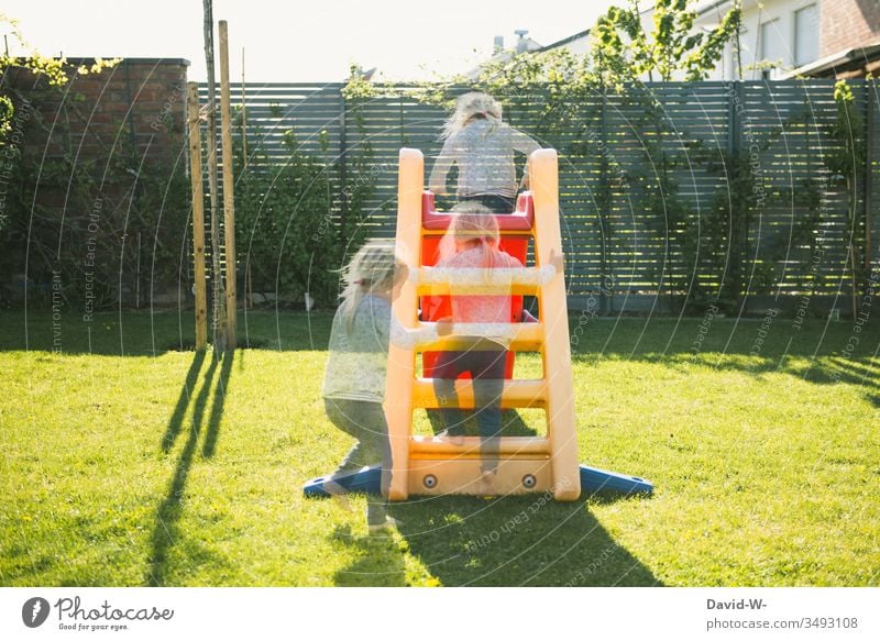 Girl plays in the garden and slides down the slide girl Child Garden Playing Skid Infancy Toddler Happiness Summer cheerful luck Human being Cute creatively