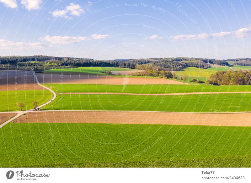 an agricultural landscape in the spring agricultural way tractor tractor path field background meadow background from above air aerial view aerial photo texture