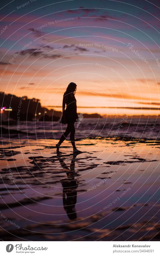 Young woman silhouette on a seashore in sunset with colourful skies and wet reef Sunset Ocean Village Sand Waves Youth (Young adults) Cool (slang) Romance