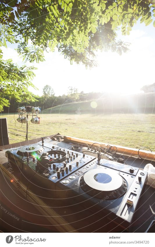 Party in nature - sunset discotheque on open field party summer celebration stage show vacation holiday music DJ equipment dance glow tree travel fun concert
