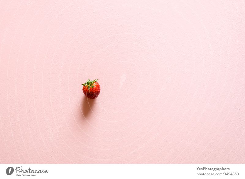 Single organic strawberry on a pink table. 1 above view berries copy space detox diet dietetic dieting flat lay food fresh fresh fruits freshness fruity