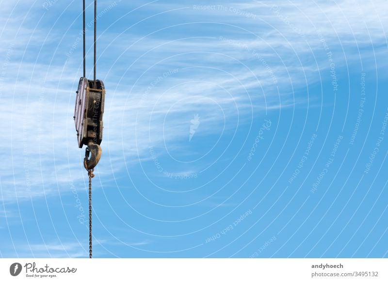 A hook of a crane with blue sky as a background at work Background building industry built structure cable cloud clouds cloudy connecting construction