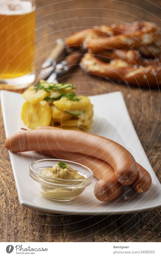 Close-up of Frankfurter sausages on rustic wood Smoked Bratwurst Hot dog German Appetizer Unhealthy homemade view seethed Red close-up beer plank snack Pretzel