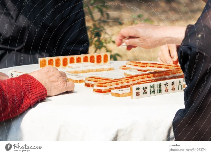 Mahjong table gambling game of Chinese senior on city street Ethnicity activity adult asia asian blocs characters china chinese content couple culture currency