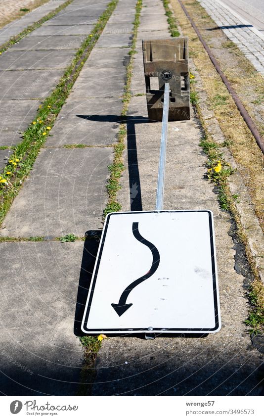Traffic sign pivoting lies fallen over on the roadside Road sign Swivel short turn display Sign stand Exterior shot Colour photo Street Transport Deserted Day