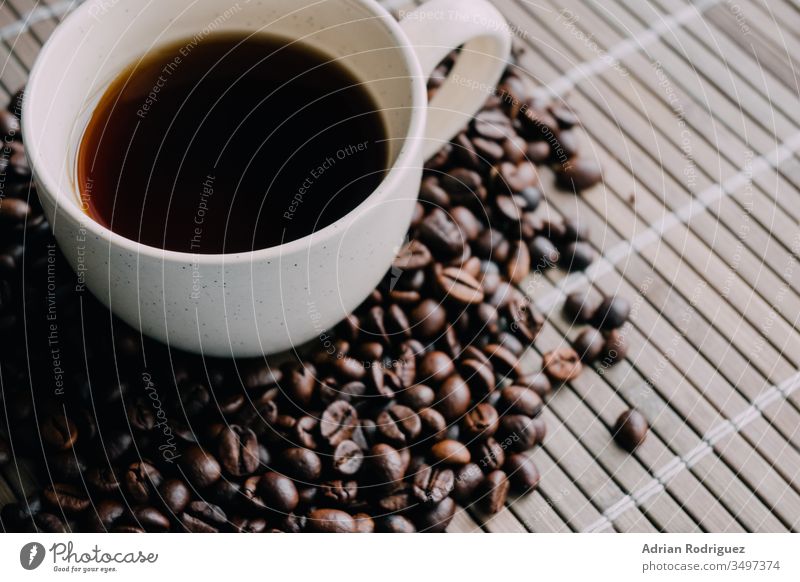 Closeup shot of a cup of coffee with coffee beans drink cafe young lifestyle beverage woman table aroma warm white adult casual tea mug morning relaxation