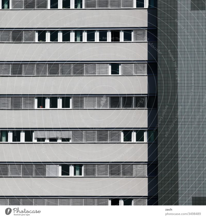 Facade of a high-rise building in grey Town Wall (barrier) Wall (building) door Architecture built Line House (Residential Structure) High-rise High-rise facade