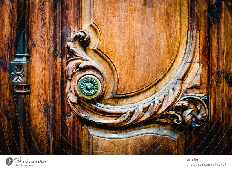 Decorated wooden door with a knob Wooden door Ornate decoration Wood work Arts and crafts Craftsman shape Structures and shapes Spirited Harmonious Front door