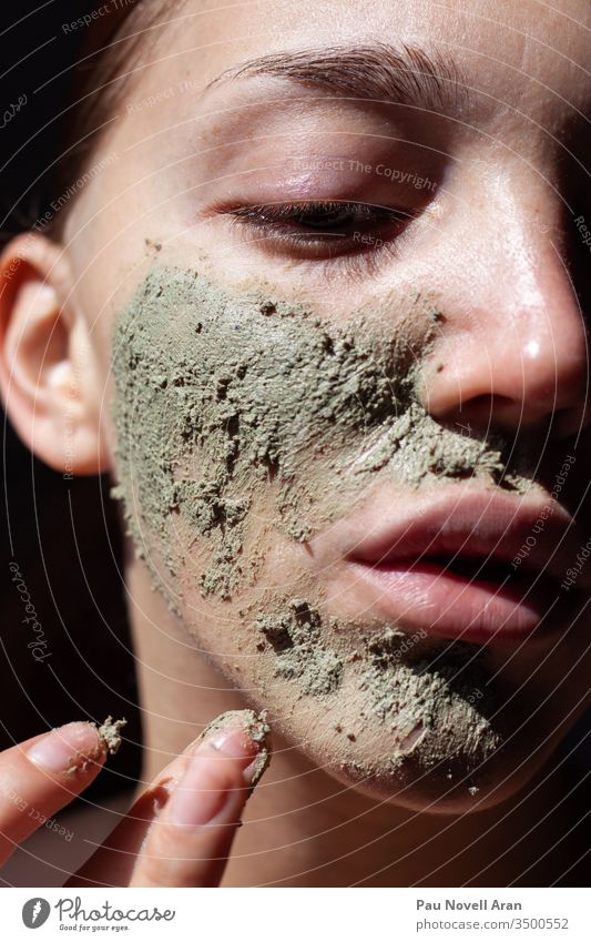 Organic cosmetic mask (scrub) with natural extracts in woman face. Cosmetology , beauty and spa dead sea green mud oil herbal massage skin acne body care dry