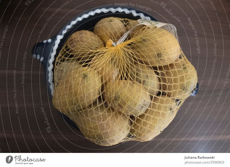 A bag of potatoes in a plastic net Potatoes Sack Nutrition Food Vegetable Colour photo Vegetarian diet Organic produce Diet Interior shot Healthy Eating Fresh