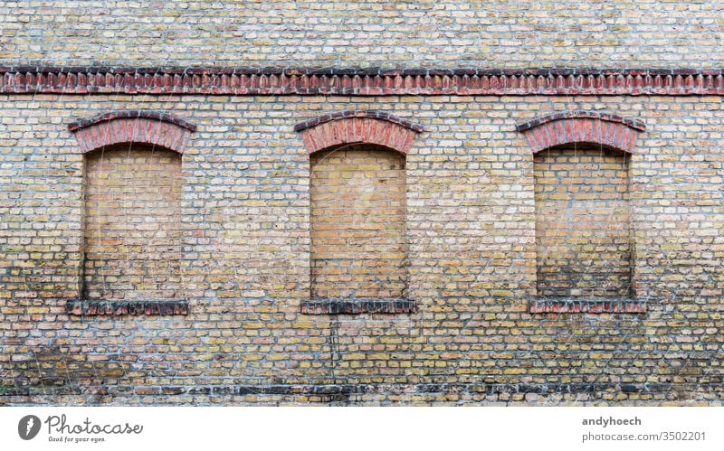 Three windows of an old house are bricked up abstract aged ancient architecture Art Background bricks brickwork brown building Business history closed color