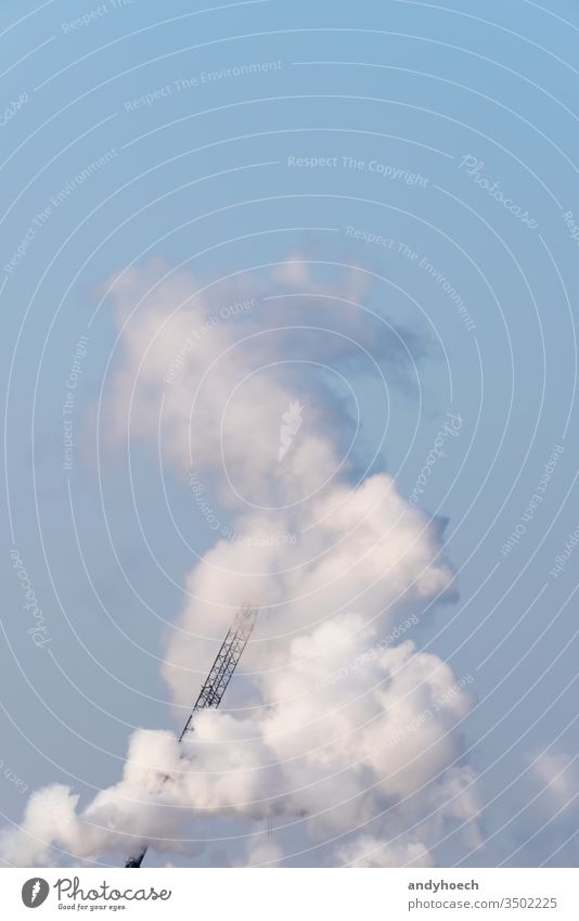 A single crane shrouded in smoke on a sunny day air architecture Background beautiful behind blue clear cloud clouds cloudy construction copy space design
