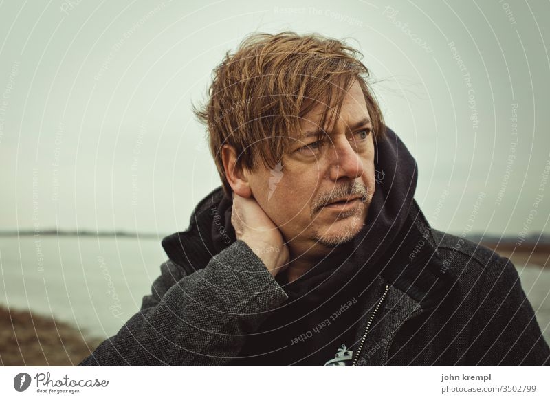 headrest Strand of hair Man portrait Human being Looking Cold Freeze Frost Winter Lake Body of water Audacious Exterior shot Coat bad hair day Tousled