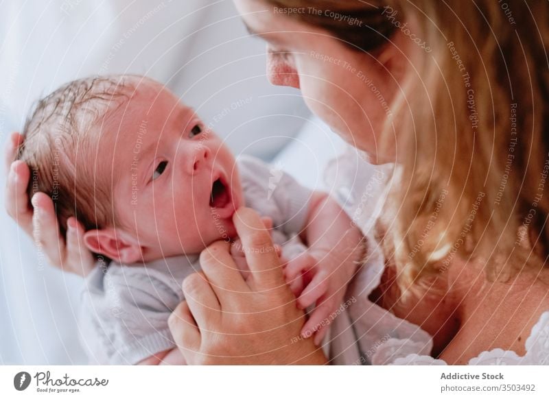Happy mother holding newborn child happy woman baby care together love motherhood smile kid parent adorable childhood innocent infant little cute comfort