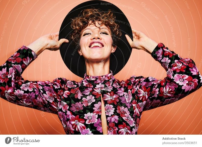Cheerful woman in stylish outfit fashion cheerful hat colorful floral style trendy smile young female model happy joy bright attractive vivid positive delight