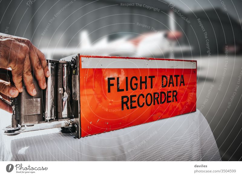 Flight data recorder from a plane. Black box, in orange color. black flight voice airplane aircraft cockpit aviation background cvr nobody equipment device