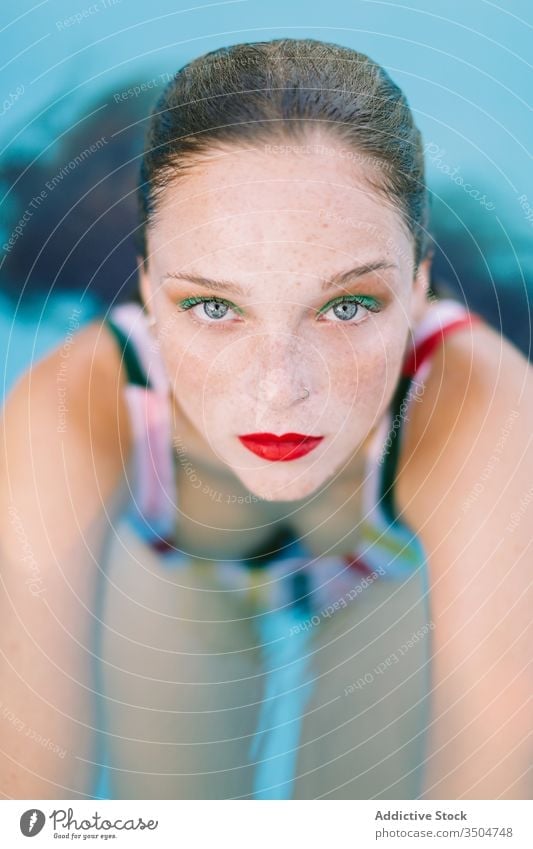 close-up of a brunette girl with long hair on a stairs in the pool water blue leisure teenager young female woman person summer fun people beautiful swim wet