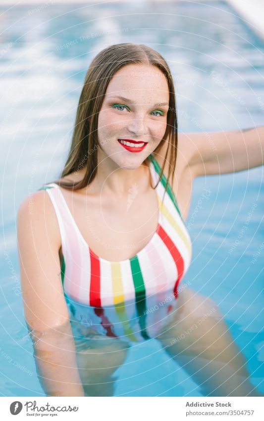 close-up of a brunette girl with long hair on a stairs in the pool water blue leisure teenager young female woman person summer fun people beautiful smile swim