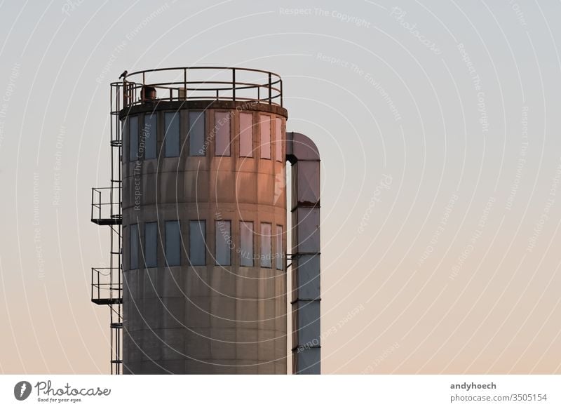 An old silo glows in the low beam afternoon architecture big building Business chemical construction container copy space cylinder depot distribution economy