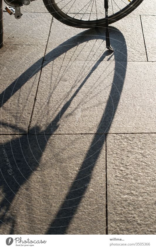 My boner casts very long shadows Shadow Wheel Bicycle Spokes Stone slab sunny Bicycle rack pennant