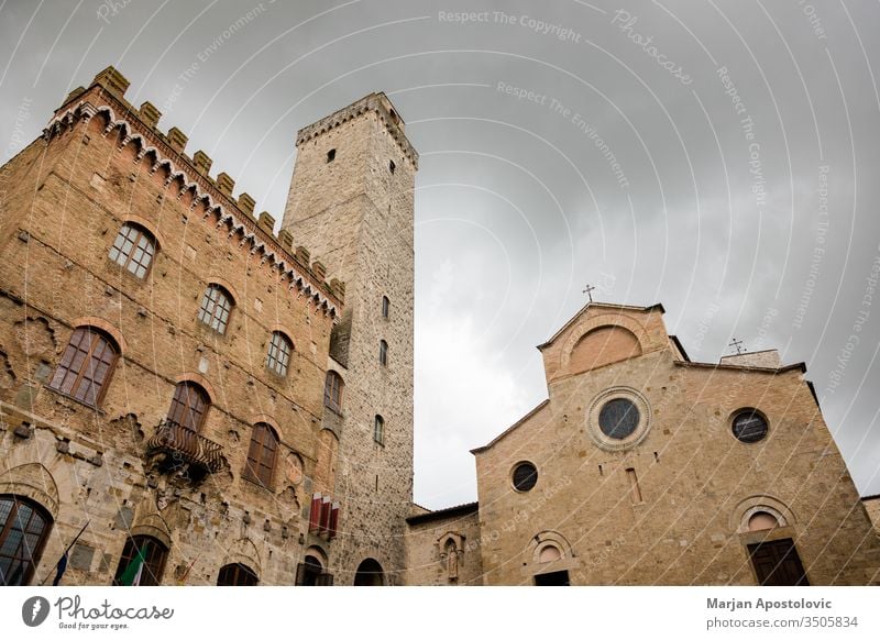 Stormy weather over high towers of San Gimignano, Tuscany, Italy ancient architecture attraction building castle cathedral church city cityscape clouds cloudy
