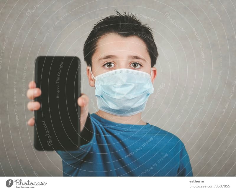 kid wearing medical mask with smartphone coronavirus child 2019-ncov epidemic covid-19 pandemic quarantine symptom medicine digital computer communication