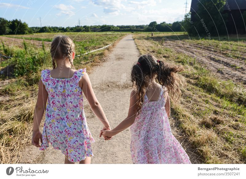 Two sisters play games Lanes & trails Village Field girls Summer Sun walk Dress happy