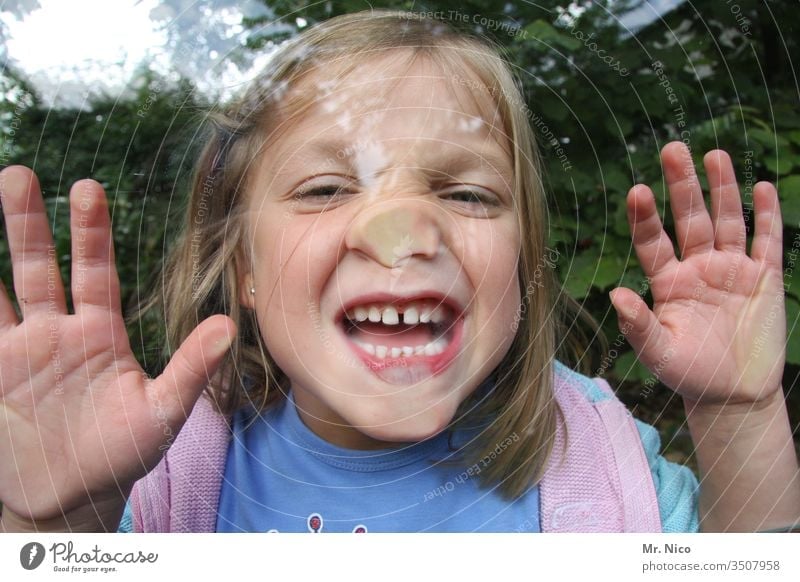 Child behind glass pane Infancy Playing Joy flat nose fun Funny Grimace grimace Face Nose Mouth Fingers Teeth Show your teeth Happiness Brash Window pane