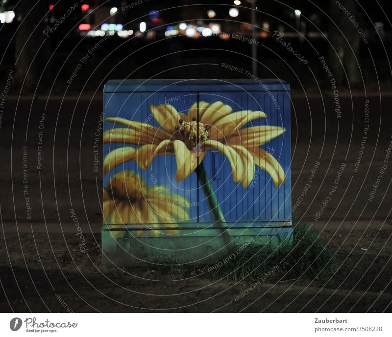 Stattblume - multifunctional housing painted with yellow flower at night Multi-functional housing Box junction box Painted flowers Art Night Street replacement