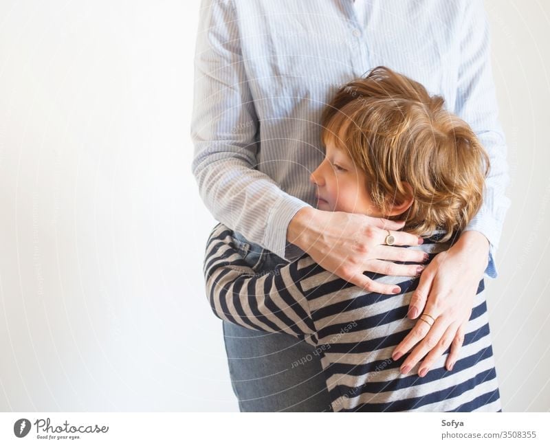 Young mother and child hugging. Mothers day mom parent mothers day woman faceless lifestyle kid love son together family emotion feelings eyes caucasian happy