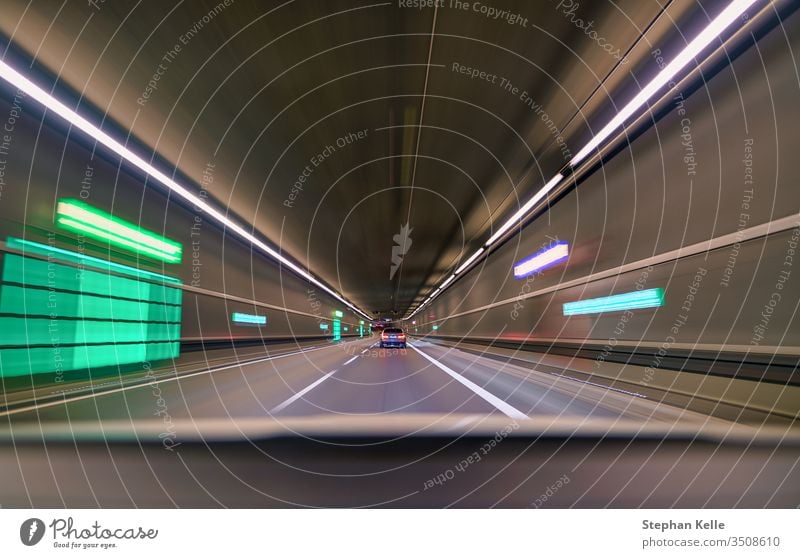 Car driving fast down interior tunnel, following another car. background grunge abstract pattern art street zoom travel highway vehicle transportation drive
