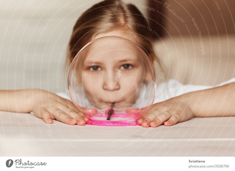 The child is holding a toy called mucus, the child is having fun and experimenting. slime game background hand white novelty entertainment isolated abstract