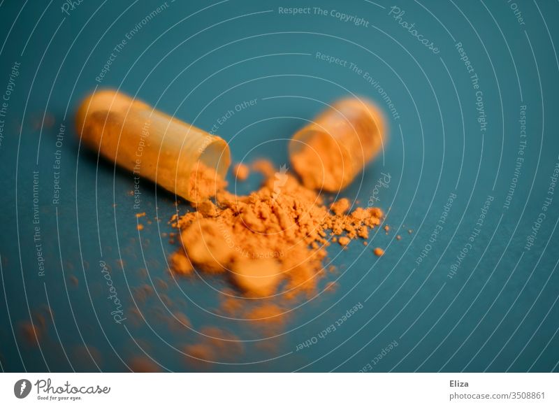 Open medicine capsule with an orange powder inside. Turmeric. Food supplement. Nutrional supplement Capsule Drug capsule Powder turmeric salubriously Orange