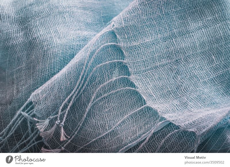 Decorative fringes of a blue cotton shawl fabric texture scarf industry textured fashion background surface design abstract closeup nobody detail clothing