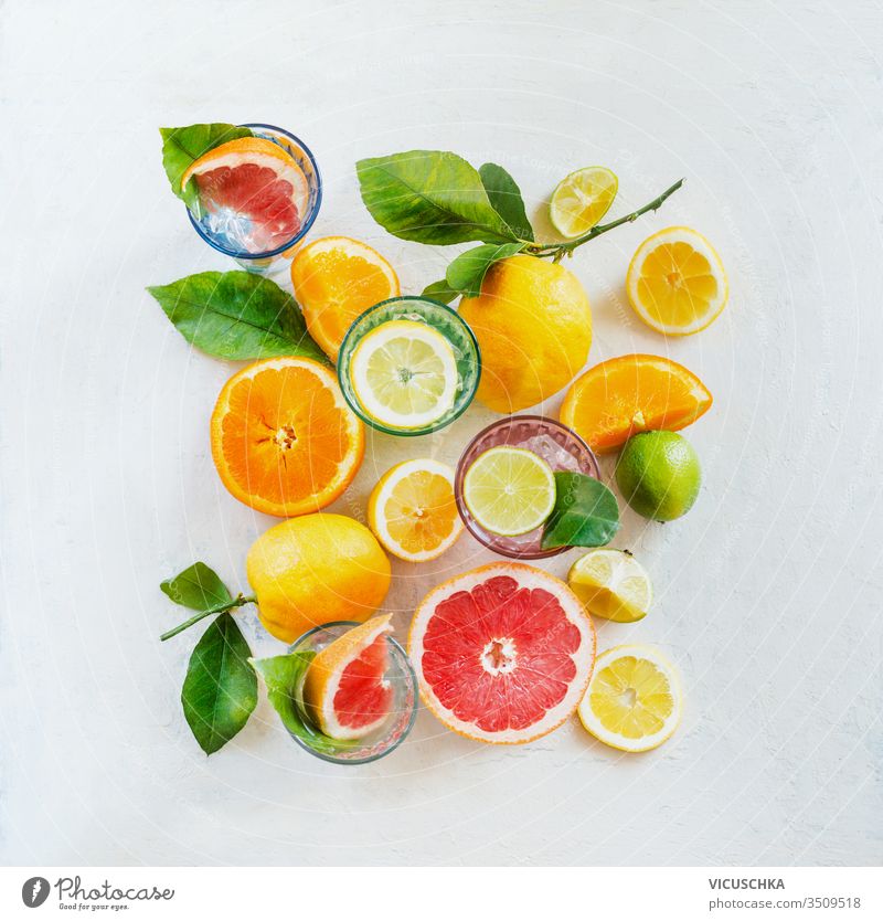 Group composition of various organic citrus fruits with green leaves on white background, top view. Healthy food.  Ingredients. Vitamin. Halves and slices. Layout