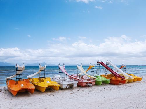 colourful pedal boats lying on the beach of Mallorca variegated Colour photo Exterior shot Multicoloured Red Day Orange green Yellow Deserted Blue Pedalo motley