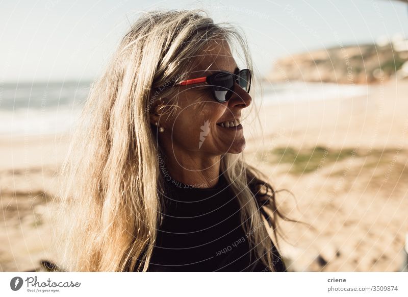 Happy senior woman with sunglasses at beach smiling beach summer happy senior adult joy leisure vacation