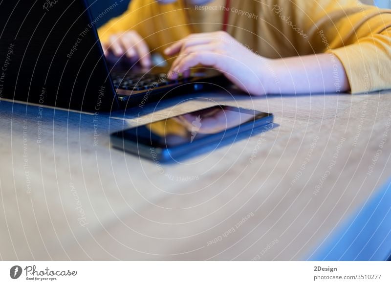 Top view of a teenager using a laptop at home table computer school lay student desk flat business cyberspace up high modern technology pen blank white hand