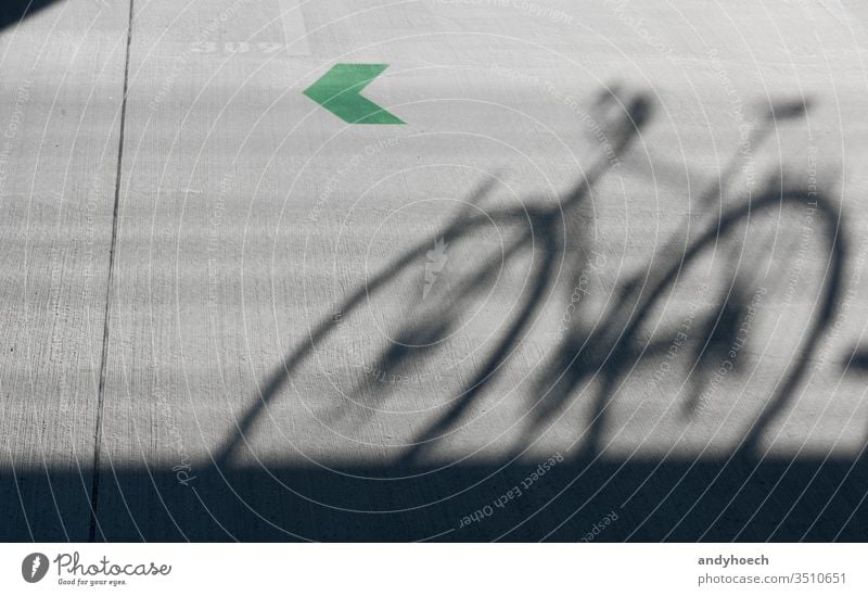 A shadow of a road bike with a green arrow 309 abstract architecture Background bicycle Bike biking black city color communication concept concrete copy space