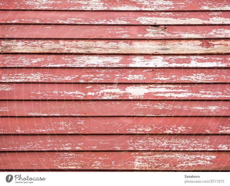 Wooden wall of old house wooden texture red paint weathered plank board outside rustic rough grungy uneven color grunge building timber