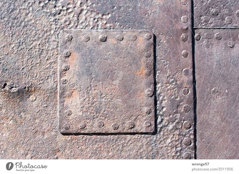 Close-up of a riveted steel patch on a heavily corroded ship's side Riveted Stud Steel boat wall Metal Old Colour photo Exterior shot Detail Deserted Rust Day