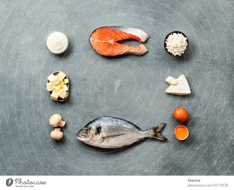 Vaitamin D sources concept, copy space, top view vitamin d food rich center flat lay fish salmon dairy products eggs mushrooms chalkboard words gray stone