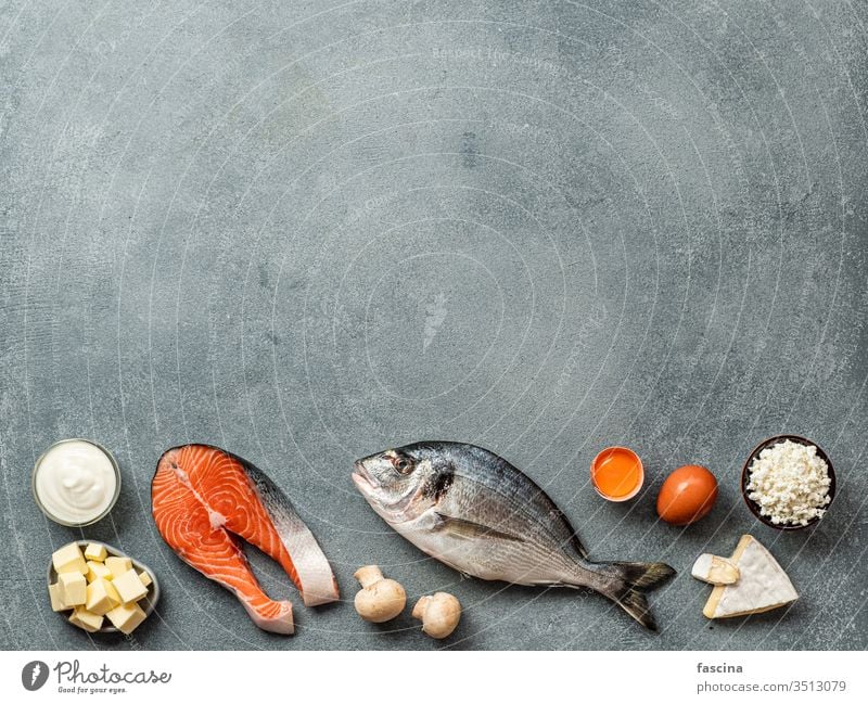 Vaitamin D sources concept, copy space, top view vitamin d food rich containing fish salmon dairy products eggs mushrooms chalkboard words gray stone background
