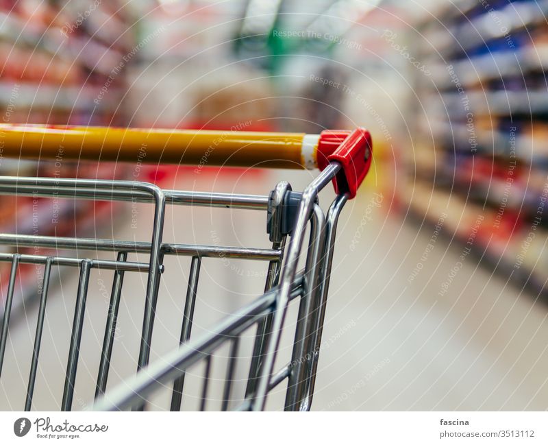 shopping trolley in supermarket aisle, copy space grocery cart food store retail shelf customer hypermarket consumer consumerism goods background buy commerce