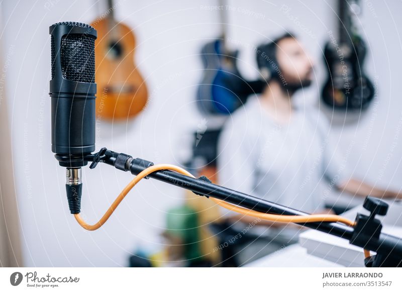 Microphone in recording studio. microphone male guitars studio recording artist audio back digital composer entertainment computer headphone hobby instrument