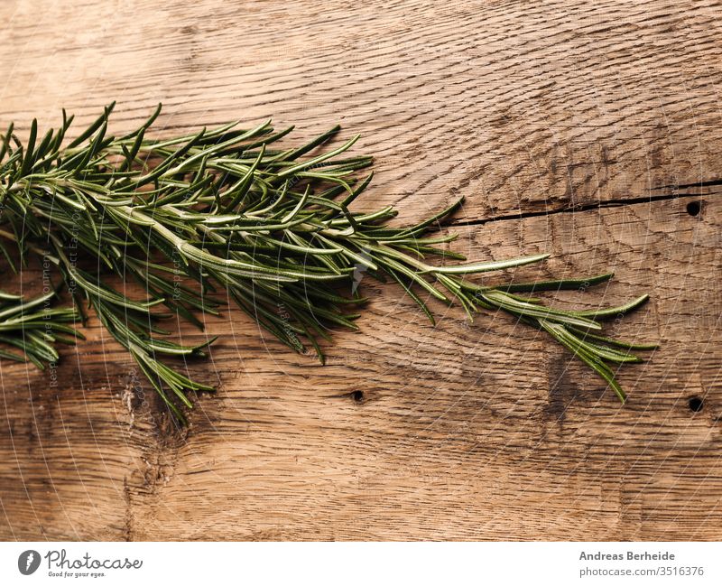 Organic rosemary on rustic wood above aroma aromatherapy aromatic background board branch bunch closeup cooking cuisine culinary dill evergreen flavor food