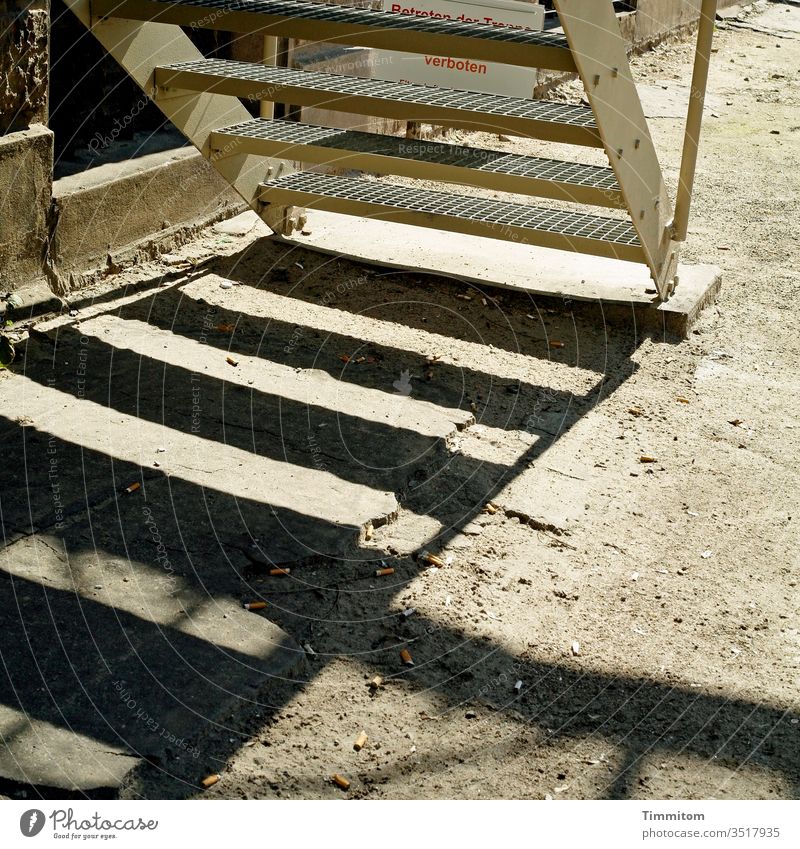 Stairs-steps-shadows Metal stagger Grating steps Shadow Building Wall (building) Ground Sand slabs Cigarette Butt Deserted Exterior shot Gloomy Signage