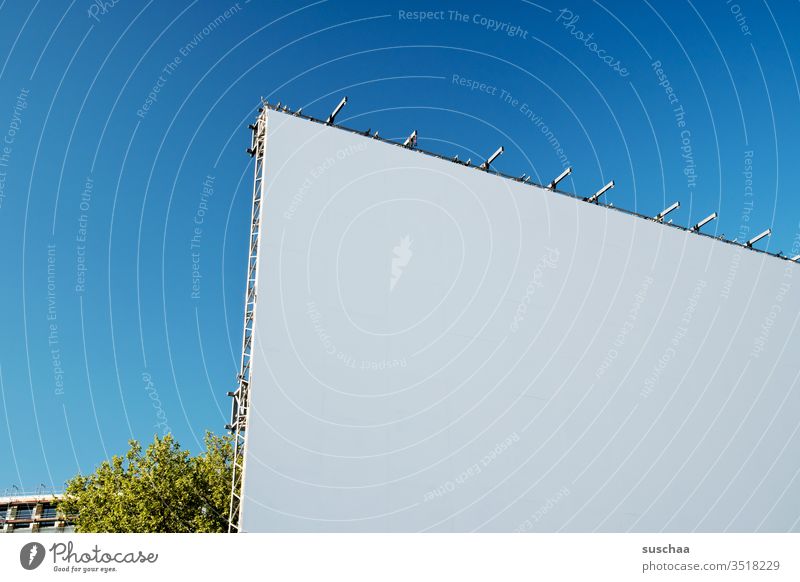 corner of a huge white cinema screen with blue sky Cinema drive-in Canvas projection screen movie Copy Space Sky Blue Blue sky white area surface Deserted